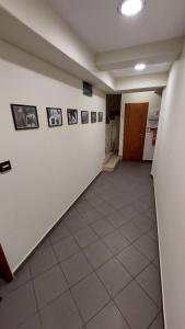 an empty hallway with pictures on the wall at Room 2 in Gotse Delchev