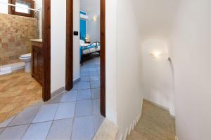 a hallway with a bathroom with a toilet and a bedroom at SanVitoTour- Residence Il Baglio in San Vito lo Capo +190 photos