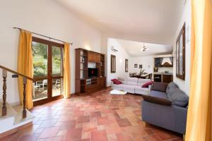 a living room with a couch and a table at SanVitoTour- Residence Il Baglio in San Vito lo Capo