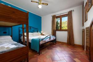a bedroom with two bunk beds and a window at SanVitoTour- Residence Il Baglio in San Vito lo Capo