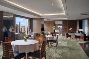 a restaurant with tables and chairs and a view of the city at Kempinski Hotel Chongqing in Chongqing