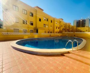 a large swimming pool in front of a building at ED. MISTRAL VIDABER in Oropesa del Mar