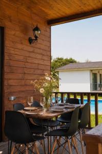 a dining room table and chairs on a patio at Matilda Village in Telavi