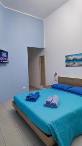 a bedroom with a blue bed with two blue pillows at Il Vicoletto in Pisticci +26 photos