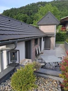 a patio with a picnic table and a building at Le Pigeonnier - Vue sur le château de Menthon in Menthon-Saint-Bernard