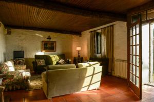 a living room with a couch and chairs in it at Casa de Sta Margarida da Portela in Vila de Punhe