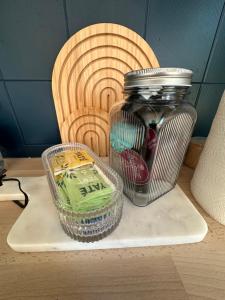 a glass jar sitting on a table next to a container at Charmant Studio in Vitré +1 photo