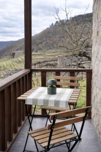 a table and chairs on a balcony with a view at uBa Vineyard Stay con vistas al Miño Ribeira Sacra in Chantada