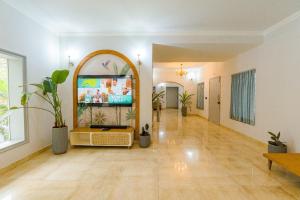 a hallway with plants and a tv in a building at Casa Mog by Meraden in Vagator
