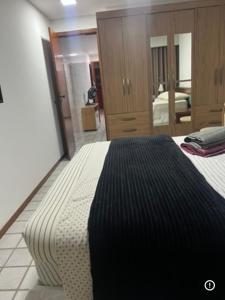 a bedroom with a large bed and a mirror at Praia da costa vista total in Vila Velha +17 photos