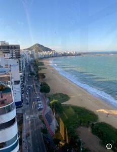 a view of a beach with buildings and the ocean at Praia da costa vista total in Vila Velha