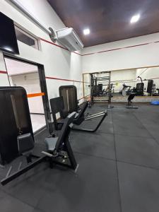 a gym with several treadmills and cardio machines at Praia da costa vista total in Vila Velha