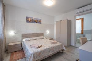 a hotel room with a bed and a bathroom at L'Aurora Porto Torres in Porto Torres