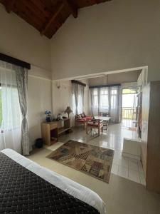a bedroom with a bed and a living room at The Himalayan Munros in Chaubattia