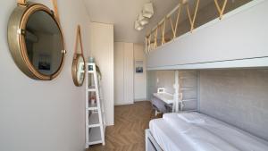 a bedroom with a bunk bed and a mirror at Solmarina, Sun&Snow in Wiślinka
