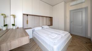 a bedroom with a large bed with white sheets at Solmarina, Sun&Snow in Wiślinka