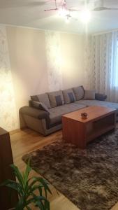 a living room with a couch and a coffee table at Fishingport in Klaipėda