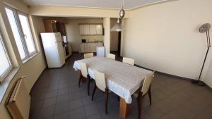 a kitchen with a table and chairs and a refrigerator at Mesta Room in Gotse Delchev