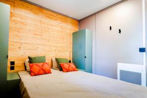 a bedroom with a bed with orange and green pillows at Le Domaine du Cèdre in Rivières +58 photos