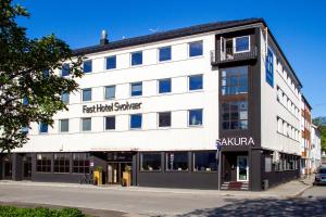a large white building with a sign on it at Fast Hotel Svolvær in Svolvær