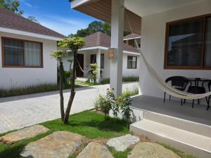a house with a hammock on the front porch at Neramit House in Ko Phangan +2 photos