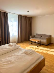 a living room with two beds and a couch at Schloss Hotel Zeillern in Zeillern +7 photos
