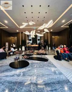 people sitting in the lobby of a hotel at Lumiere Riverside Grand Prestige Residence in Ho Chi Minh City