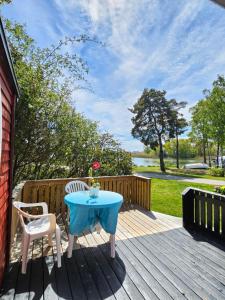 a table and two chairs on a wooden deck at Stuga 11 Dalskärs camping in Bergkvara