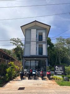 a group of motorcycles parked in front of a building at Dana Residence in Ko Yao Noi