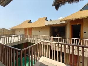 a group of houses with thatched roofs at The Ark Resort in Bhopal