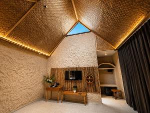 a room with a table and a tv on a wall at The Ark Resort in Bhopal