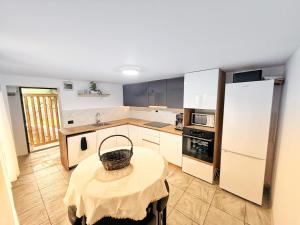 a kitchen with a table with a basket on it at Wild Rose in Borşa