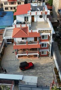 a red truck parked in front of a building at Mandala Living Kathmandu in Kathmandu