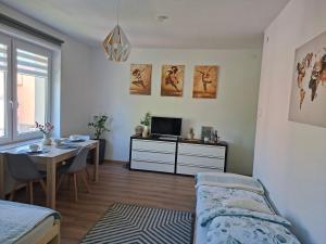 a bedroom with a bed and a table with a desk at Apartament VERDE Malbork centrum in Malbork