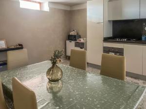 a kitchen with a table with a vase on it at Casa Vacanze Francesca in Mondolfo