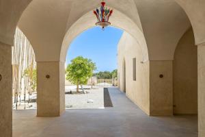 an archway with a chandelier in a building at Masseria LOGGIA PUCCI in Torre Chianca