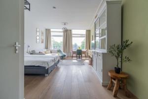 a bedroom with a bed and a living room at Job Baster Kraanplein - Het Zonnehof in Zierikzee