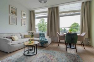 a living room with a couch and a table at Job Baster Kraanplein - Het Zonnehof in Zierikzee +23 photos