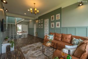 a living room with a couch and a table at EKOSTAY I Pearl House Villa I 360 Degrees Tea Estate in Ooty