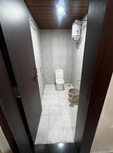 a small bathroom with a toilet in a room at Seasons Resorts in Jabalpur