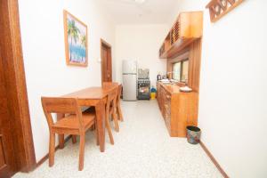 a kitchen with a table and chairs and a refrigerator at Mnazi Dream House in Kiwengwa