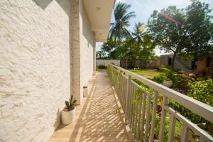 a porch of a house with a fence and a plant at Mnazi Dream House in Kiwengwa