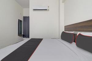 a room with a bed and two chairs in it at Collection O SS Metro Ritz in Hyderabad +21 photos