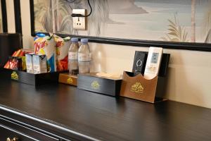 a counter in a hotel room with bottles of water at Nhật Long Hotel in Giap Ninh Binh