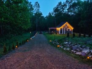 a barn with lights on the side of a road at 2R Relax Resort in Ubyszów