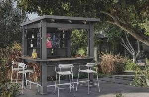 a bar in a shed with stools around it at Садиба in Vinnytsya