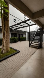 arium of a building with stairs and a tree at ADD Hóteis Congonhas in São Paulo