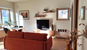 a living room with a couch and a flat screen tv at Rauchhof in Auer