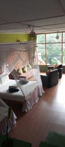 a bedroom with a bed with a mosquito net at Ayanura Ella in Ella