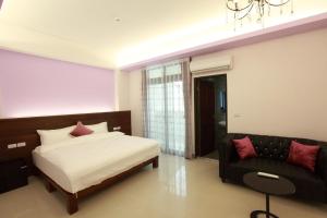 a bedroom with a bed and a couch at Yulibnb in Yuli